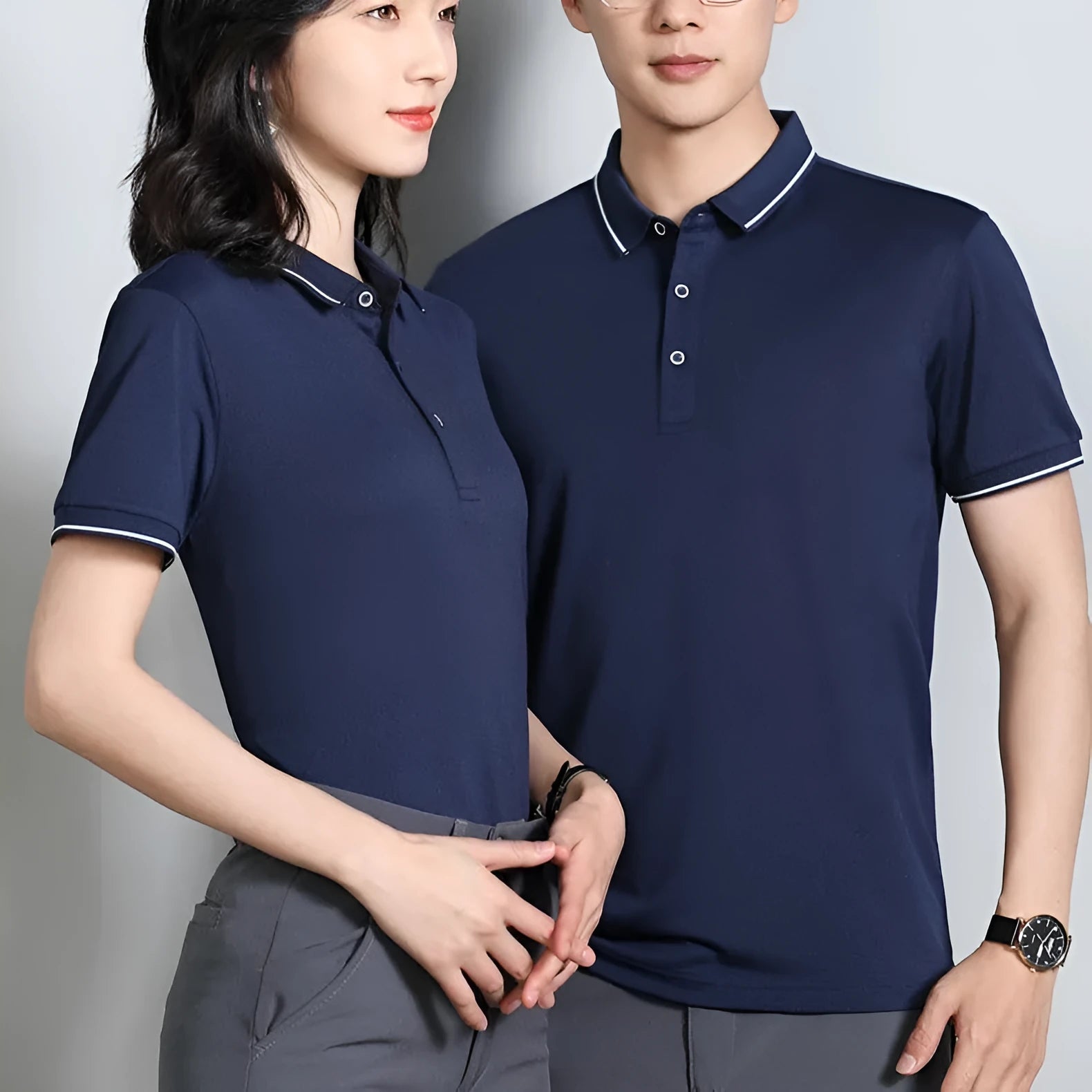 Short-sleeved beautician work polo shirt in cool silk cotton on a hanger, showing asymmetric detail and collar.