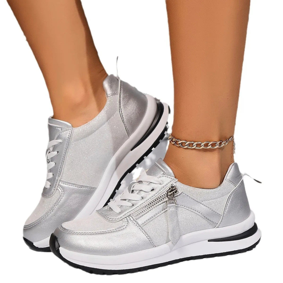 Gold women's flat sole lace-up pumps with round toe on a white background.