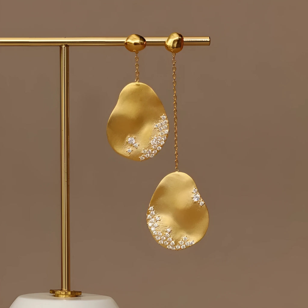 Asymmetric floral earrings with zircon stone detailing in gold-plated silver or gold finish