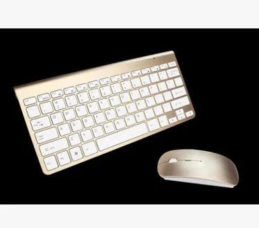 2.4G wireless keyboard and mouse combo set in silver colour on a desk with laptop