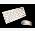 2.4G wireless keyboard and mouse combo set in silver colour on a desk with laptop