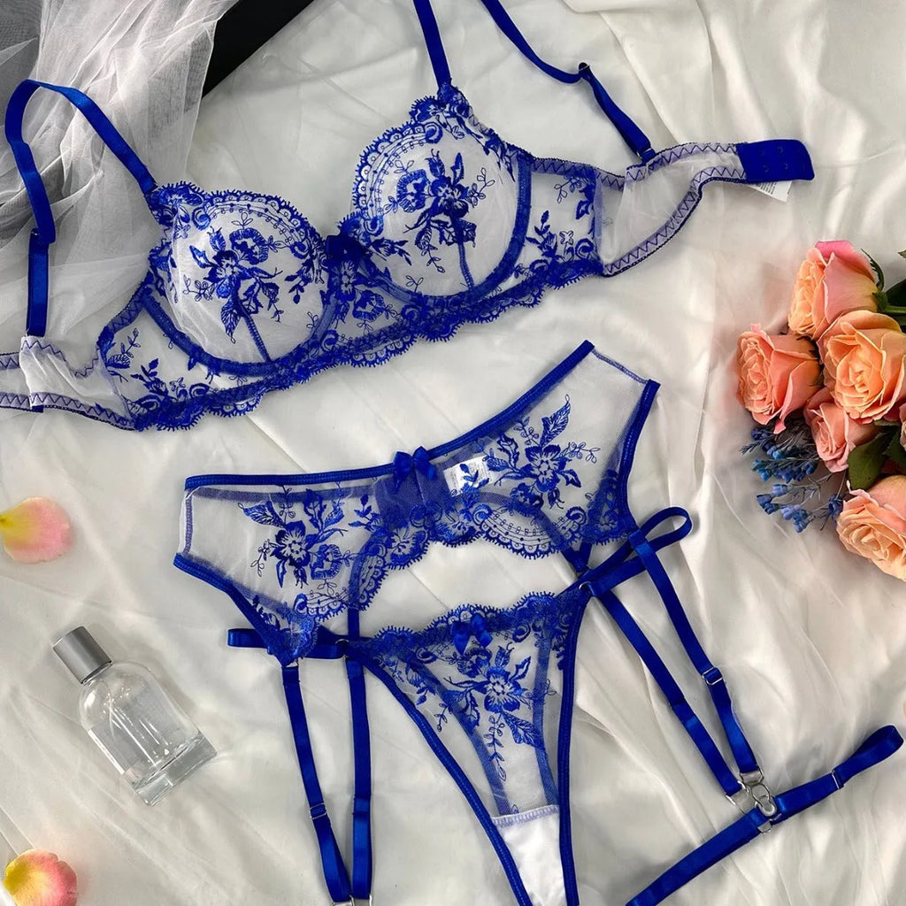 Women's embroidered see-through cutout lingerie set in polyester, shown in sapphire blue, including top, t-pants, and garters.
