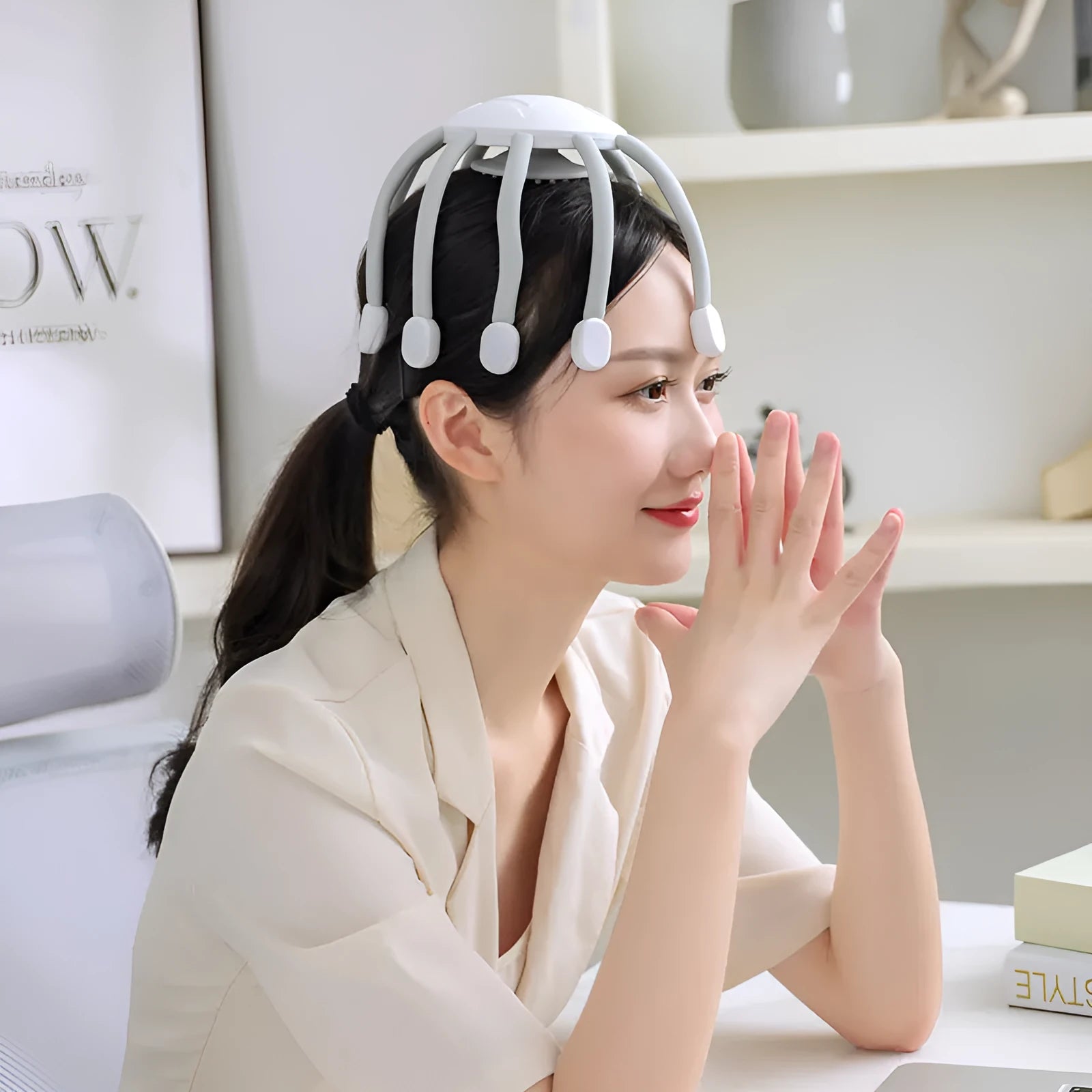 Black handheld head massager with multiple vibrating nodes for scalp stimulation