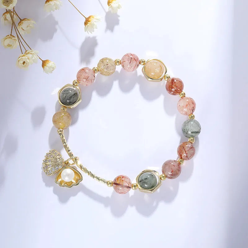 Colourful crystal shell bracelet with hair crystal detailing and red sealant flower shell accents