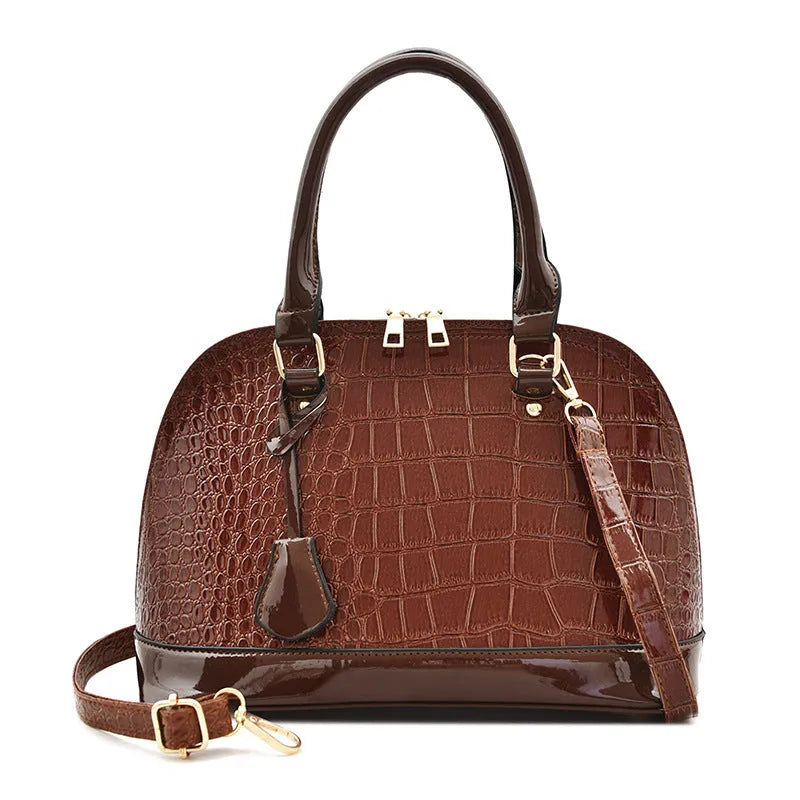 Shiny PU crossbody bag in shell shape measuring 22x30x15cm with polyester lining in black colour