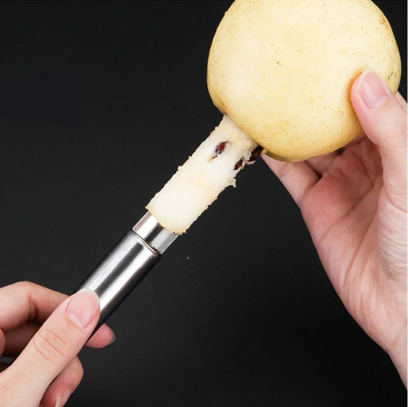 Stainless steel pineapple corer slicer with ABS handle showing pineapple preparation