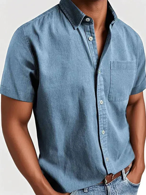 Man wearing a solid colour short-sleeved shirt with a polo collar and a single chest pocket.