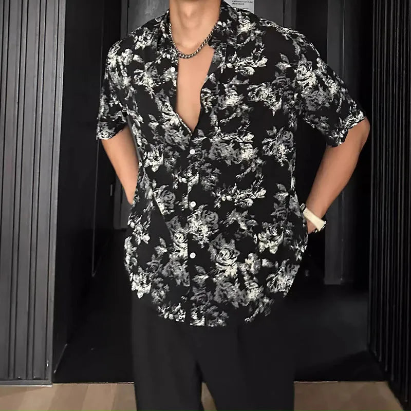 Black and white loose-fit floral printed short sleeve casual shirt on a hanger.
