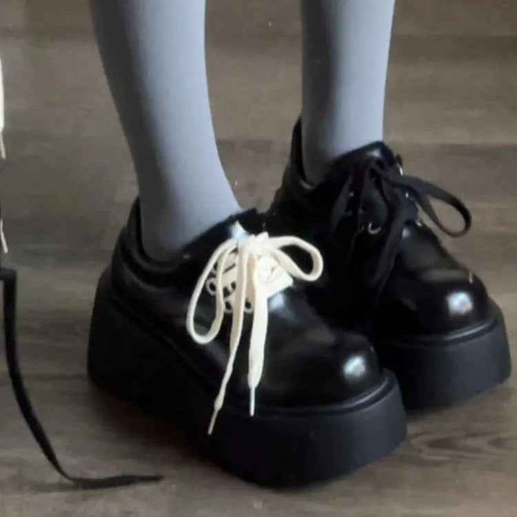 Women's matte black lace-up platform ankle boots with a thick sole and round toe.