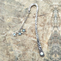 Retro five-pointed star glowing metal bookmark in ancient silver and bronze colours with celestial patterns