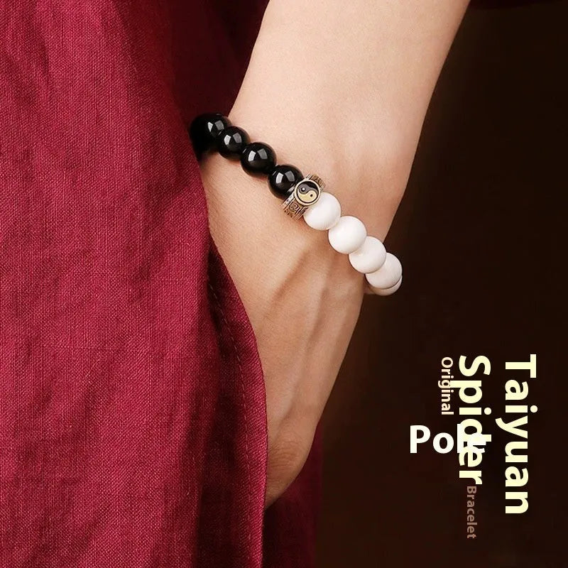Black and white woven Taiji and Mantra bracelet on obsidian beads.