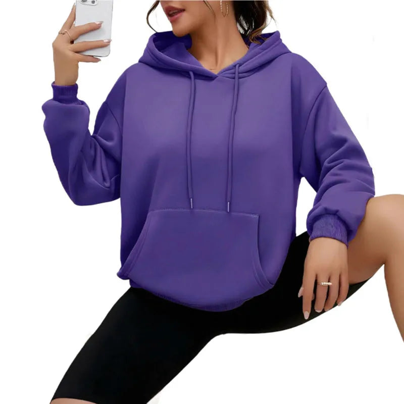 Women's loose fit grey sweatshirt with a drawstring pocket and long sleeves on a hanger.
