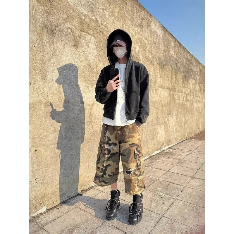 Men's loose-fit camouflage coloured cropped jeans with ripped details and straight-leg cut.