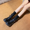 Black women's mid-calf knight boots with metal buckle straps and a side zipper.