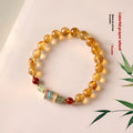 Yellow citrine prayer wheel bracelet with 8mm beads on wrist