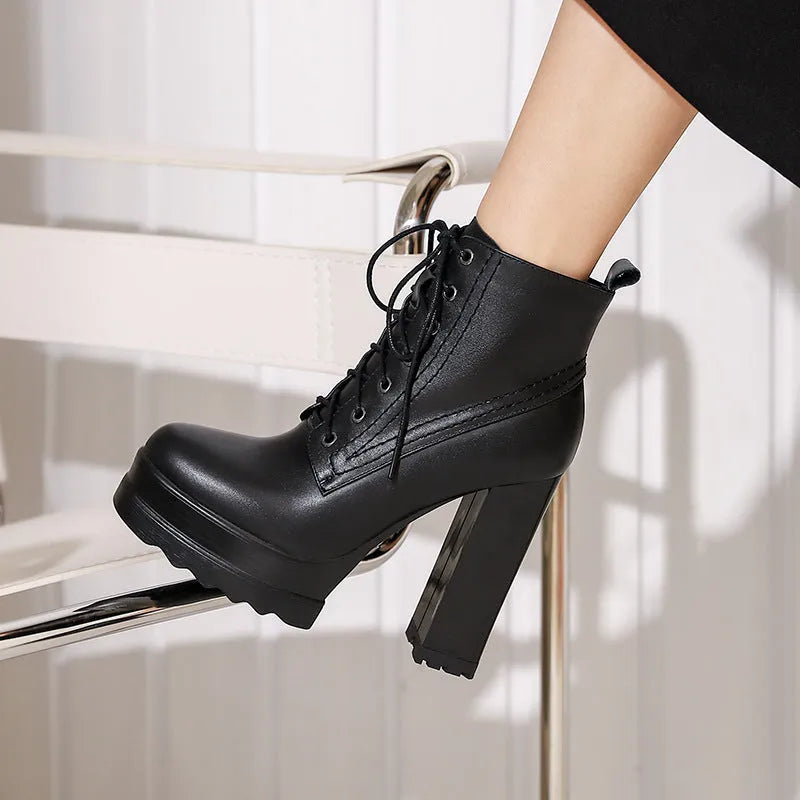 Women's black waterproof platform high heel boots with a chunky block heel and side zip.