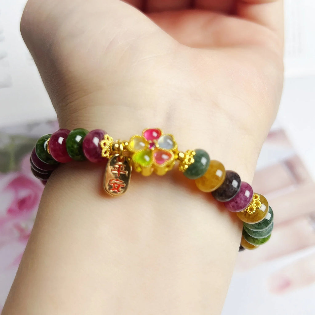 Colourful artificial crystal abacus bead bracelet with tourmaline-style stones on wrist