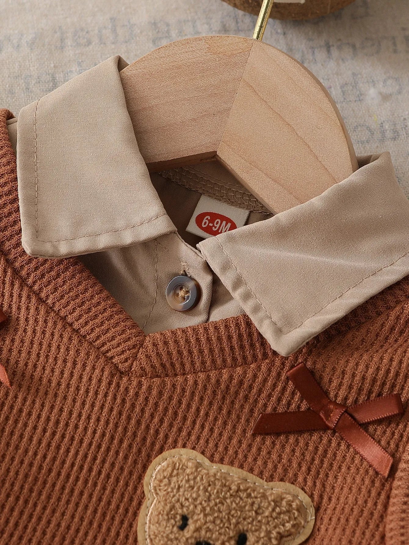 Girls' light brown plaid three-piece set with top, knitted vest, and pleated skirt on white background