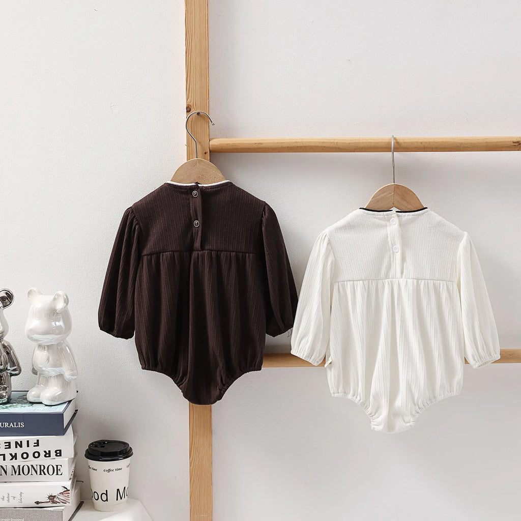 Cotton baby bow long sleeve onesie in black or white, triangle jumpsuit style, sizes 66-100cm