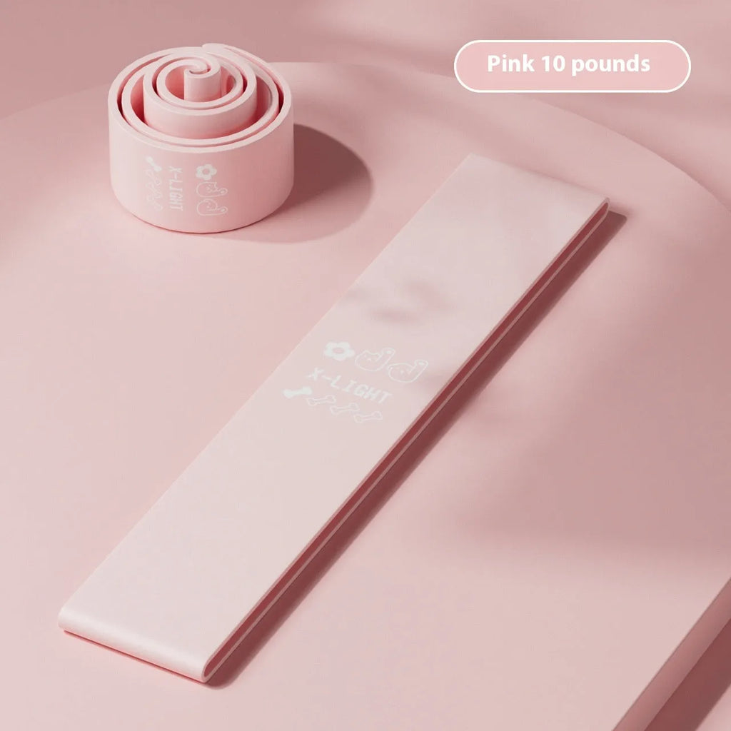 Set of four plastic elastic resistance bands in pink, orange, beige, and green colours, representing different strength levels.