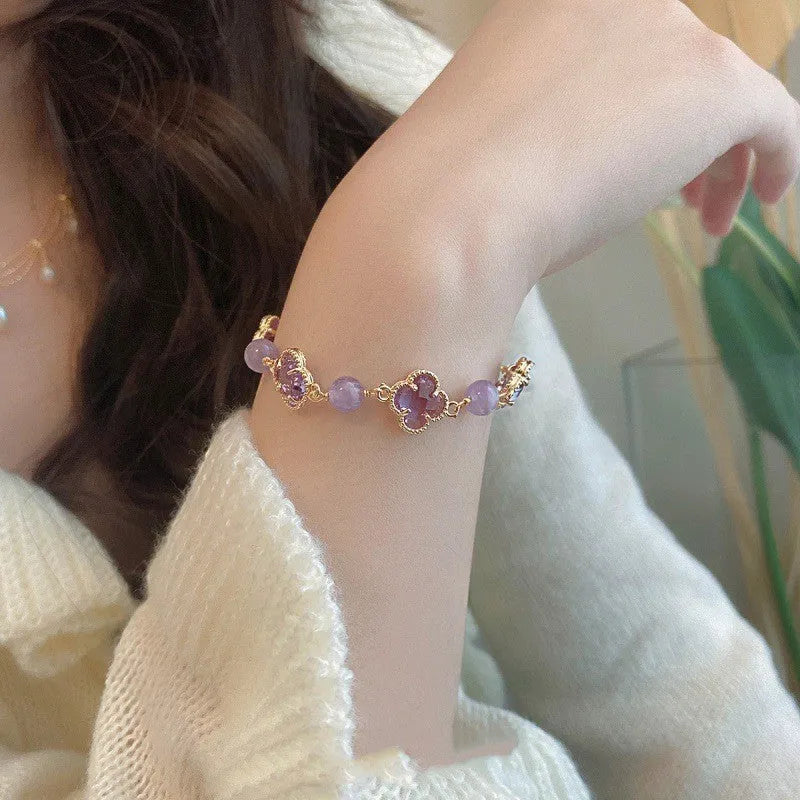 Women's artificial amethyst four-leaf clover bracelet with pearl accents on U-shaped electroplated chain.