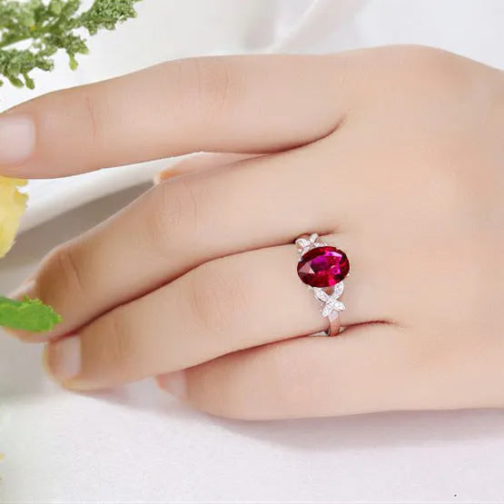 Women's butterfly and heart-shaped ring in copper with rose gold plating shown in red and blue colour options