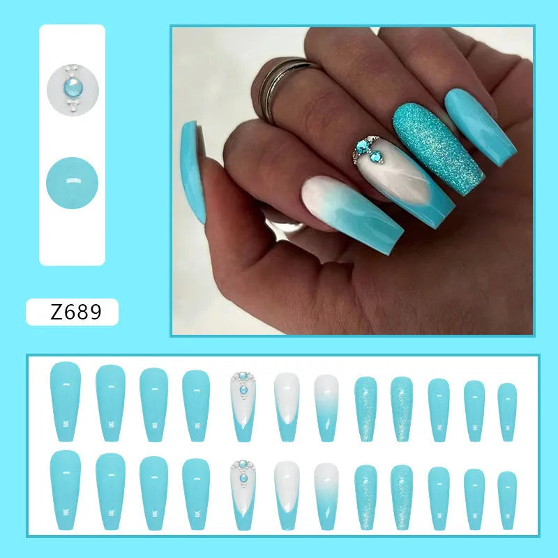Long ballet-shaped false nail art patches in solid smart blue diamond colour with a tube of nail glue.
