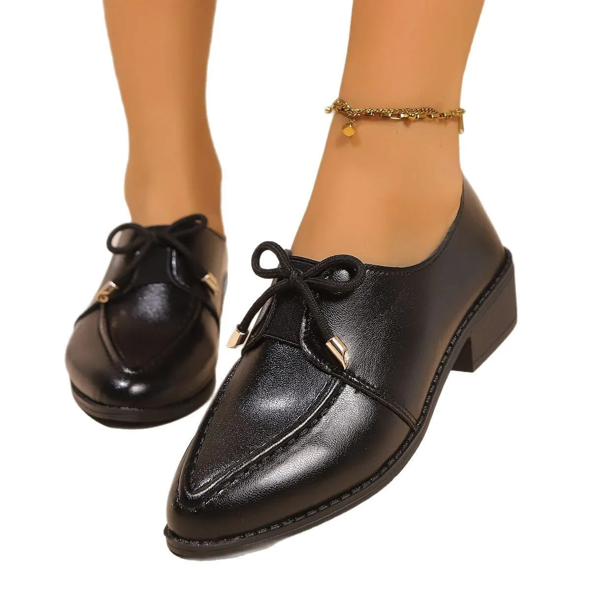 Women's beige PU leather slip-on shoes with a large bow decoration and rubber sole.