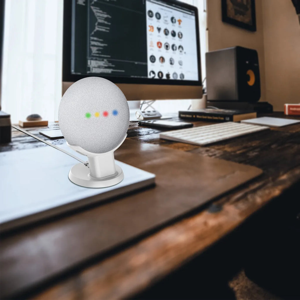 Black PlusAcc Google Home Mini stand with plug-in base on a table.