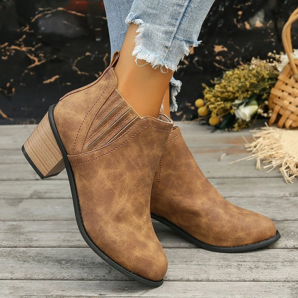 Women's black pointed toe ankle boots with a thick square low heel, made of artificial PU.