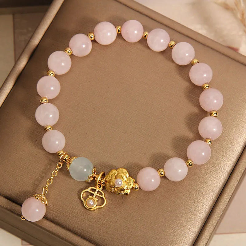 Close-up of a women's pink crystal flower bracelet on an adjustable chain.