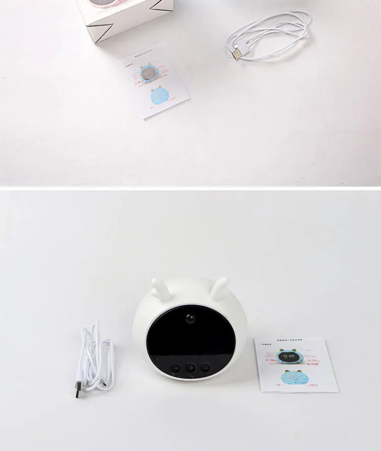 Silicone smart alarm clock with voice control, human body sensor, and luminous display on a bedside table.