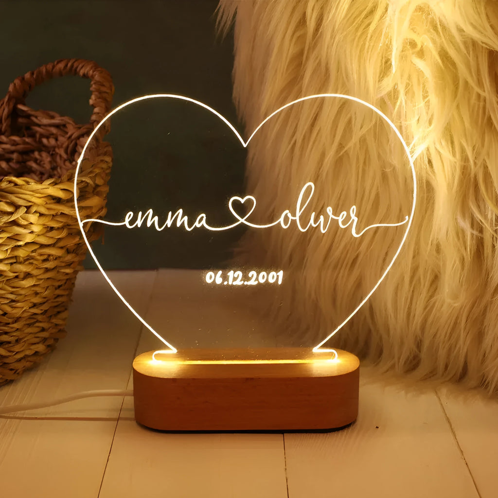 Custom transparent acrylic LED night light etched with personal names and date.