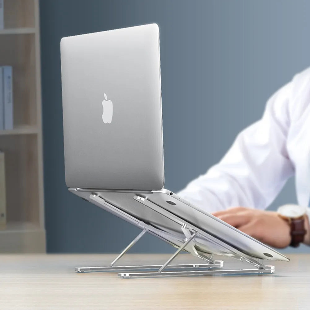 Foldable aluminium laptop stand in silver colour, shown adjusted to a height with a laptop on it
