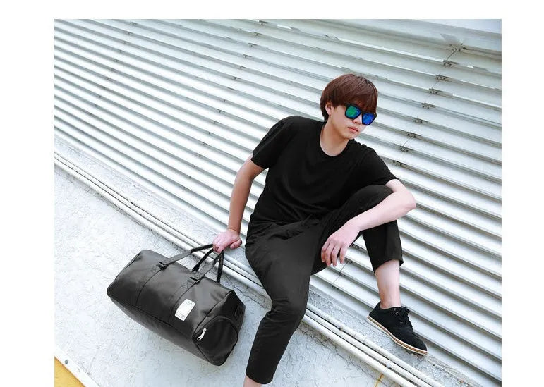 Black waterproof sports fitness bag with separate shoe compartment and diagonal strap.