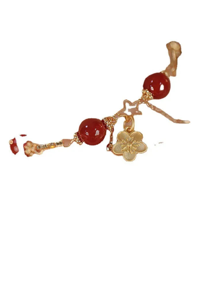 Close-up of a red agate double layer women's bracelet with floral and peach blossom motifs.