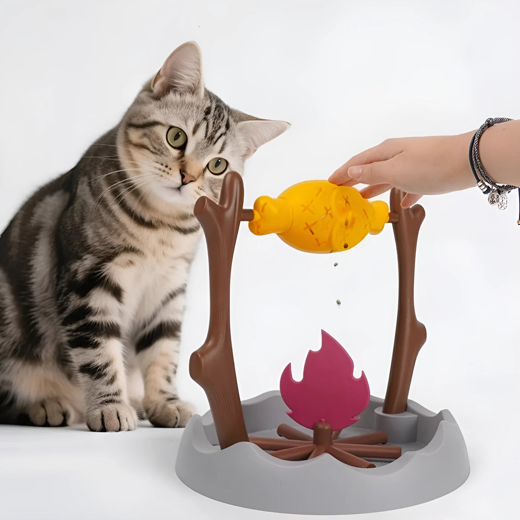 Barbecue style tumbling cat feeder toy for interactive food puzzle play.