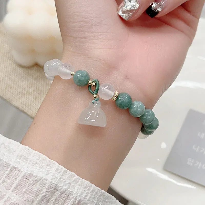 Close-up of a women's retro Chinese style agate bracelet with a lotus seedpod design.