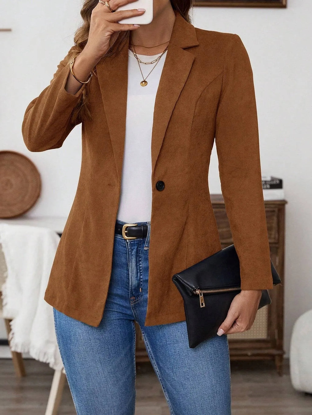 Brown single-breasted men's suit blazer with notch lapels on hanger