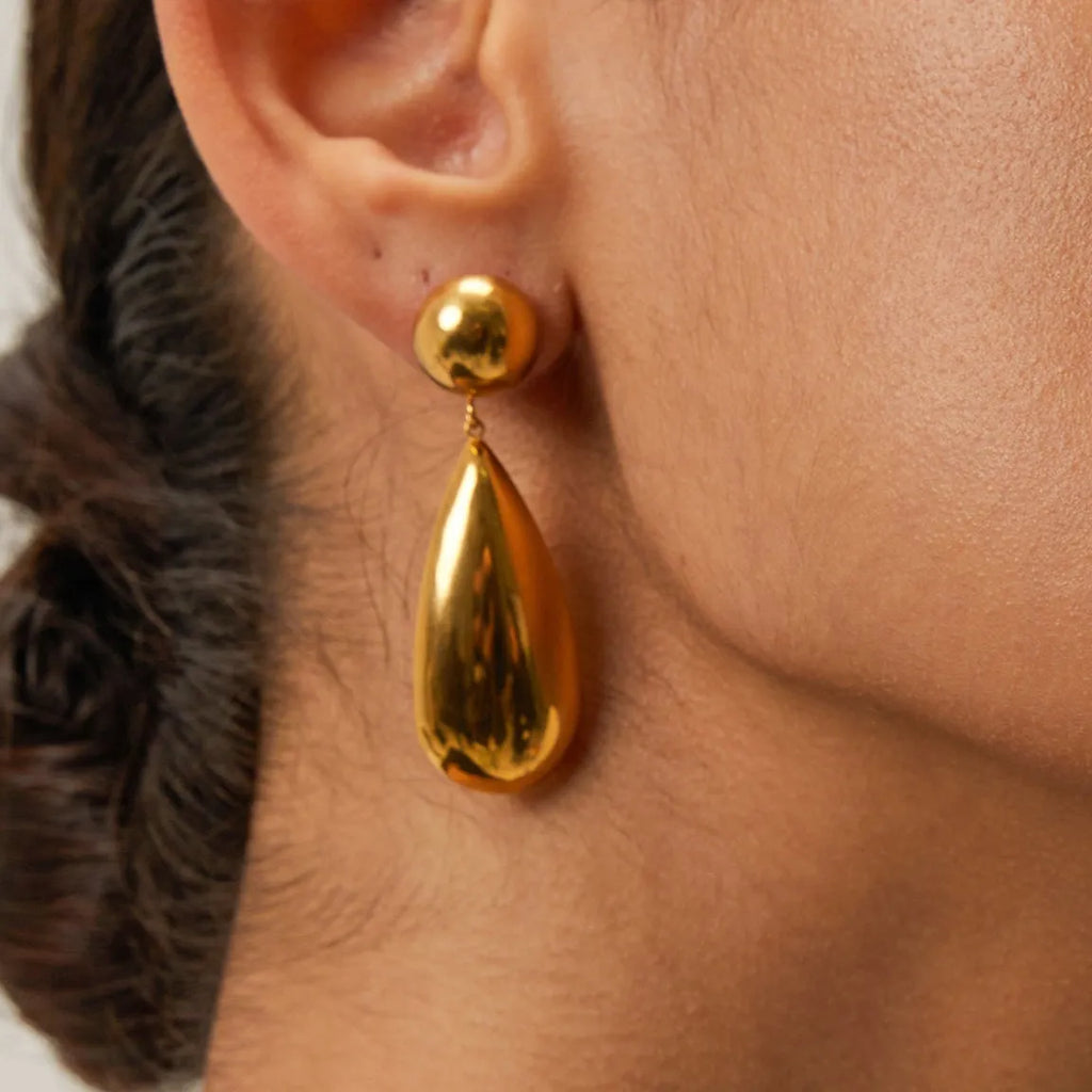 Gold coloured stainless steel earrings with a geometric shape and water drop pendant.
