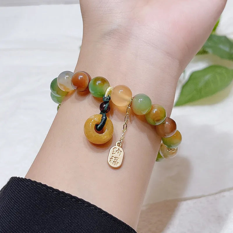 Yellow gold tone peacock agate and old mine topaz bracelet with peace buckle closure