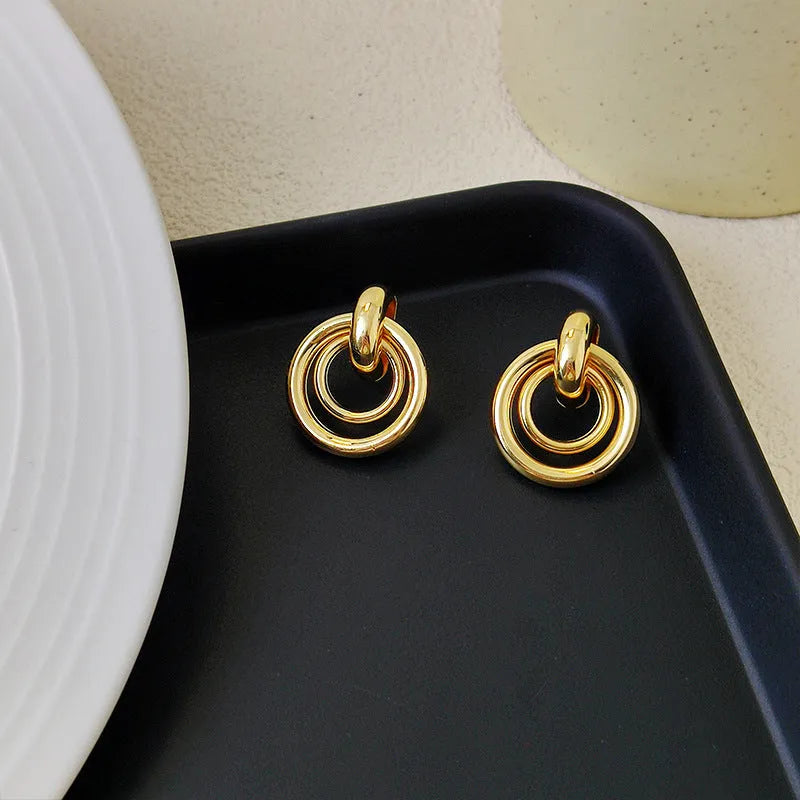 Geometric round ring earrings for women with electroplated gold or silver finishes and irregular contemporary design