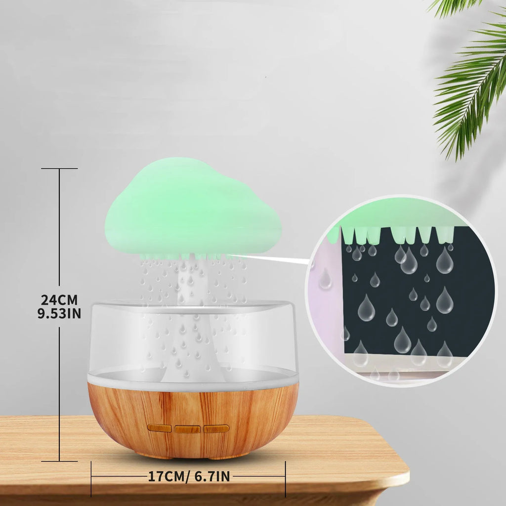White cloud-shaped humidifier with multi-colour night light on a table.