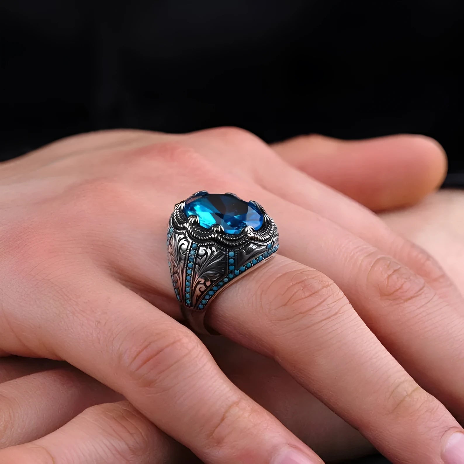 Geometric antique silver alloy couple ring with a blue zircon stone in a Grandmother Diamond setting.