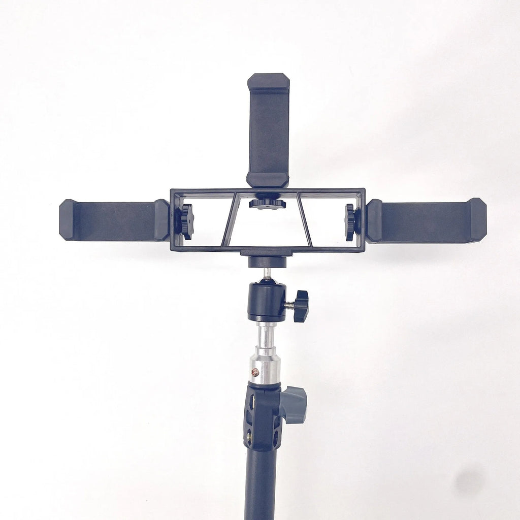 Black mobile phone tripod extended to 1.1m on a desk showing metal legs and phone mount