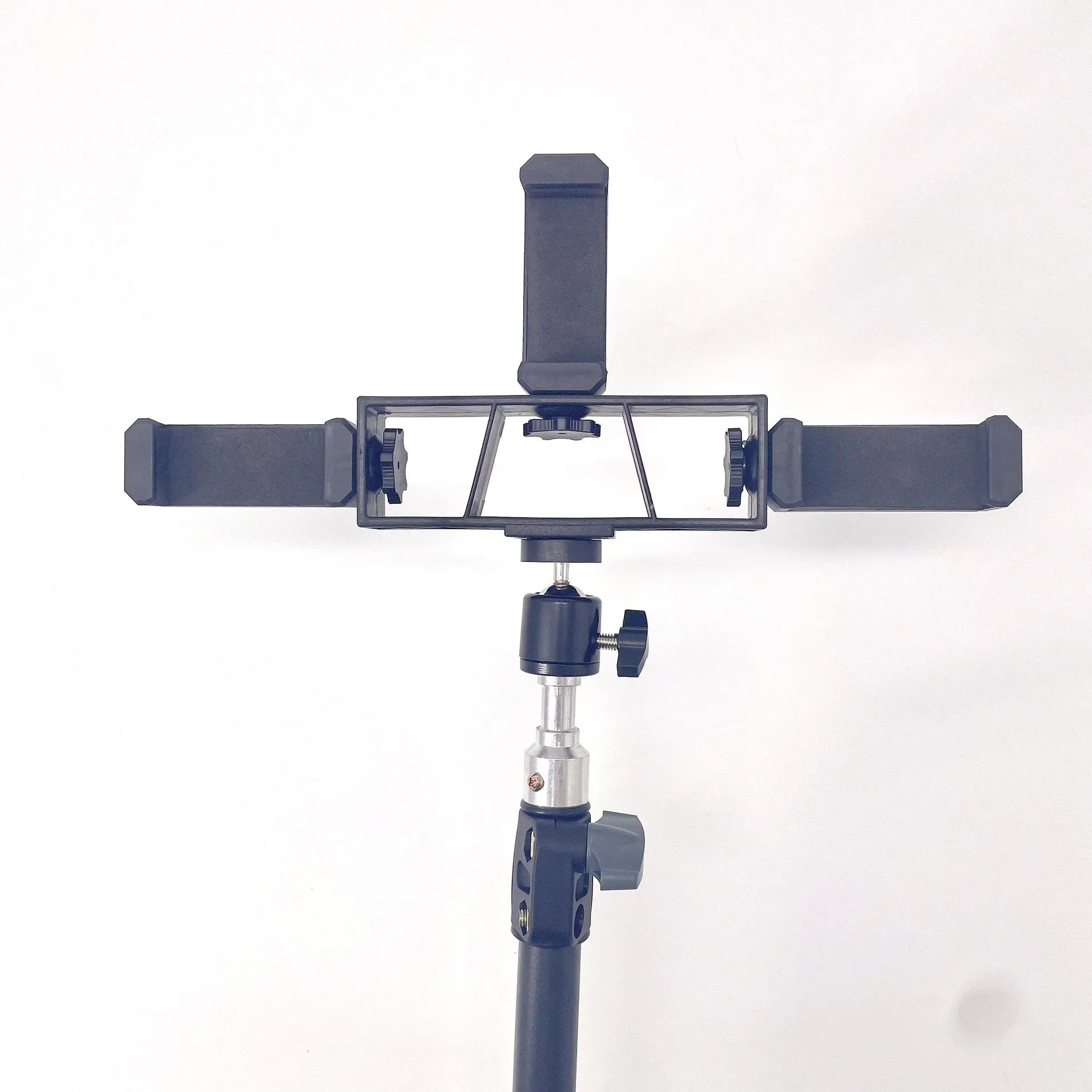Black mobile phone tripod extended to 1.1m on a desk showing metal legs and phone mount