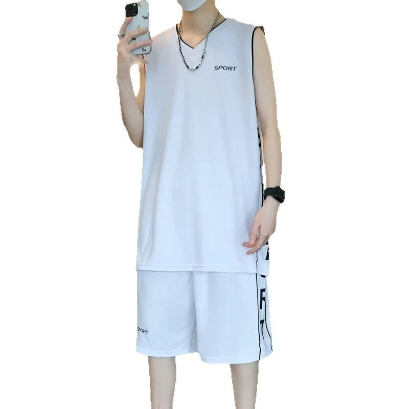 Man wearing a grey sleeveless polyester vest and matching shorts basketball sports set.