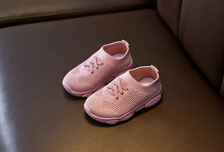 Children's lazy slip-on shoes in white, black, pink, or grey with fabric upper and rubber sole.