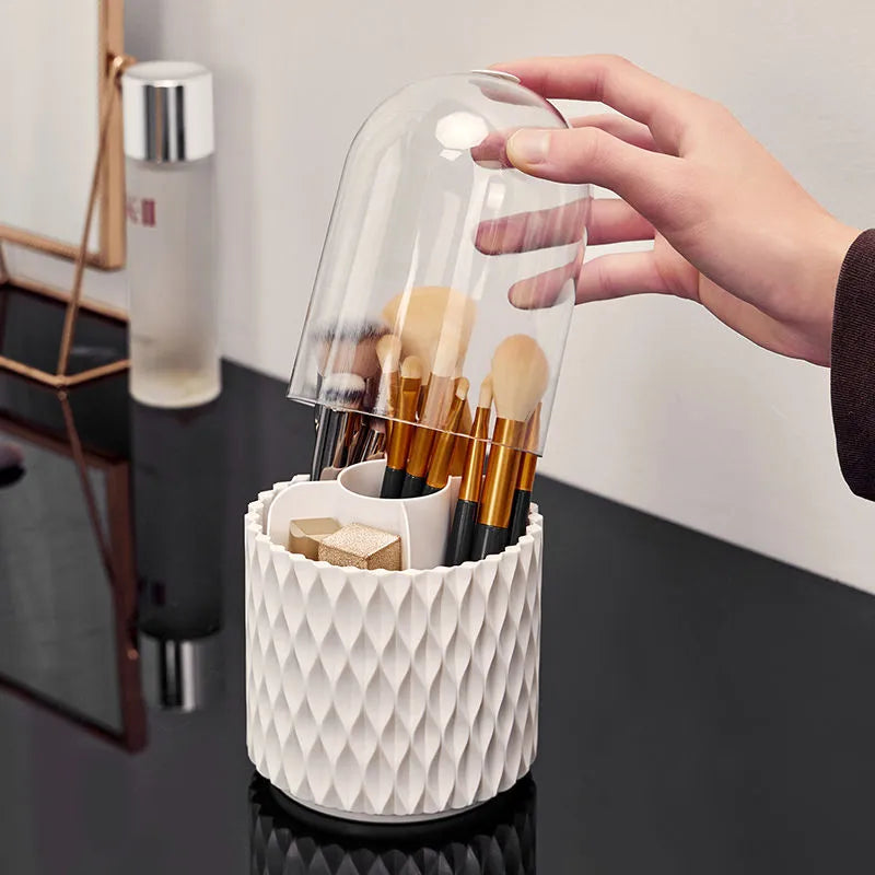 White rotating makeup brush storage holder with transparent lid on desktop