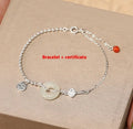 Women's silver bracelet with Hetian jade and a traditional Chinese peace buckle charm on a geometric link chain.